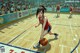 A woman dribbling a basketball on a basketball court.