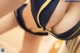 A close up of a woman in a blue and yellow bikini.